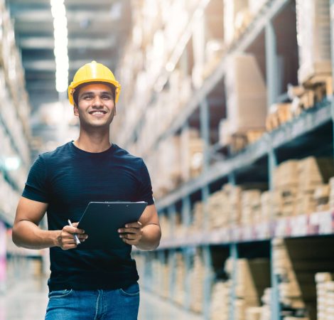 smart-indian-engineer-man-wearing-safety-helmet-doing-stock-tick-check-cardboard-stock-product-management-factory-warehouse-background (1)